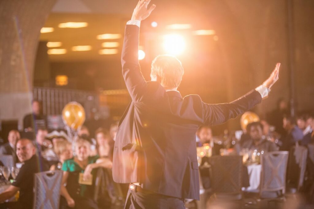 Guest at corporate event playing a part in murder mystery party