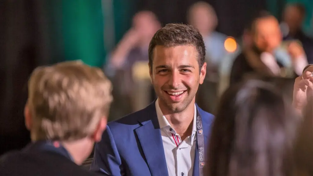 Murder mystery party guest at corporate event smiling