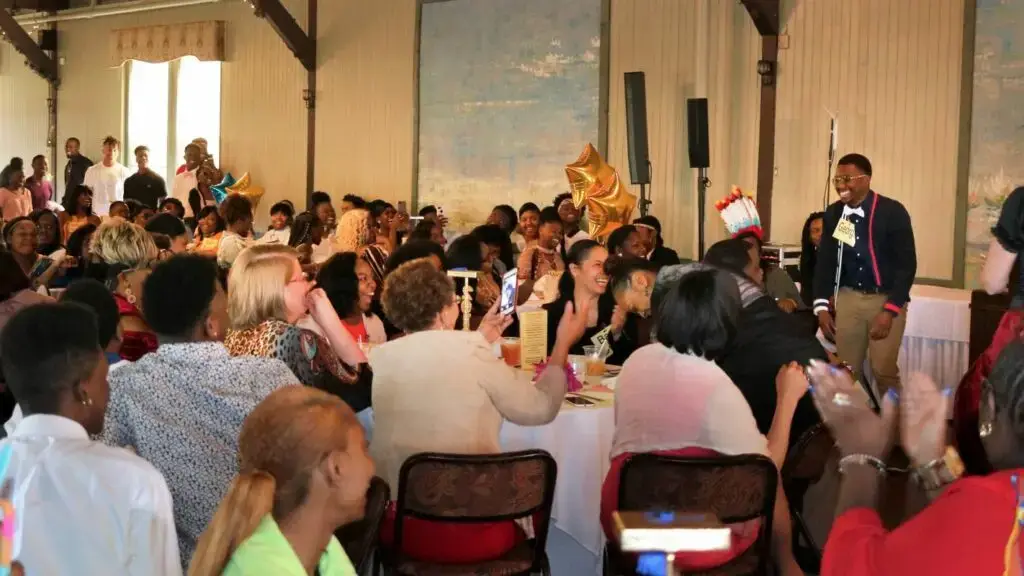 Large audience laughing at murder mystery dinner party