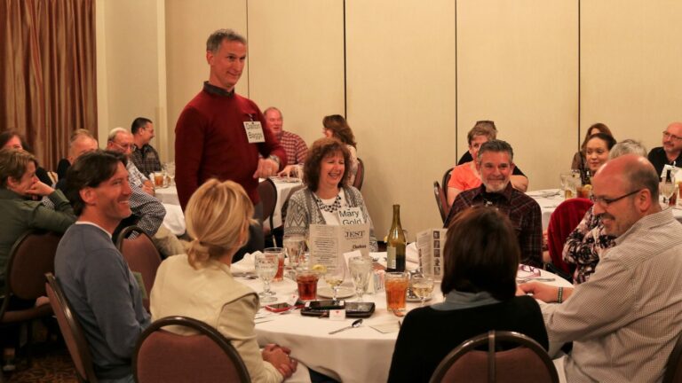 Coworkers laughing and enjoying murder mystery party