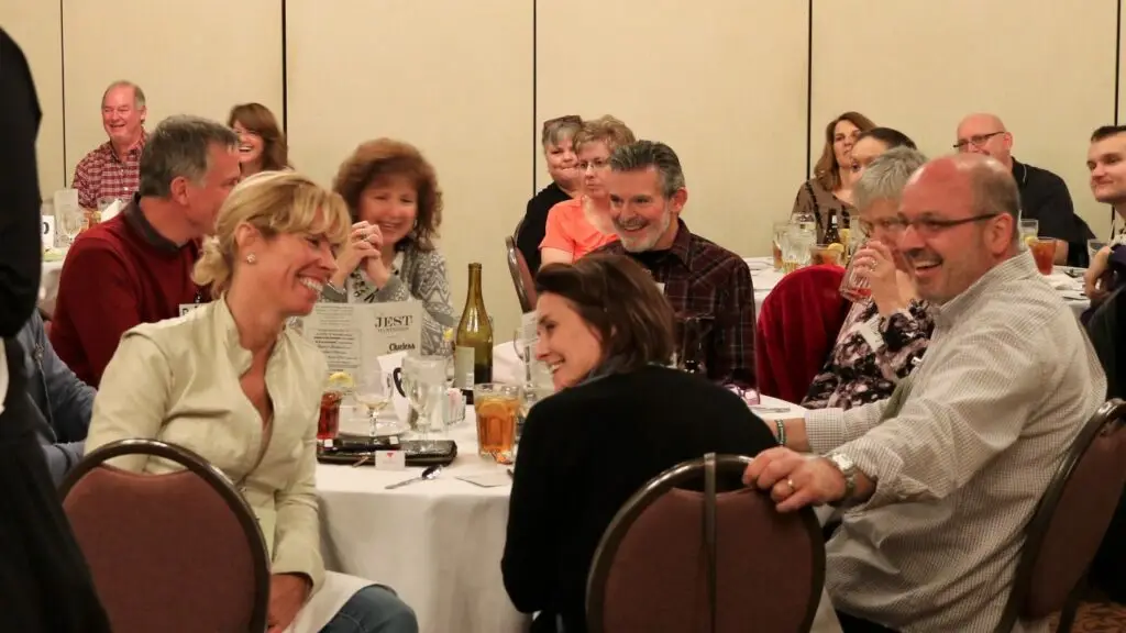 Guest at Jest Murder Mystery Co. murder mystery dinner laughing and having fun