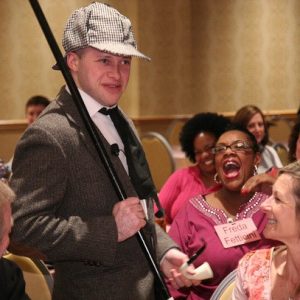 Murder mystery audience laughing as detective performs for company party