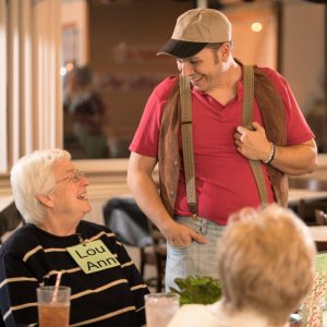 Murder mystery actor and guest laughing during show