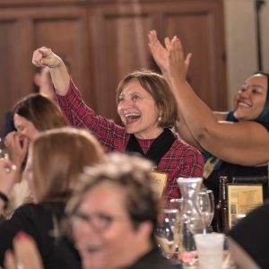 Murder mystery party guests laughing and smiling