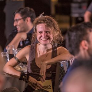 Guest at murder mystery party for corporate event laughing and smiling