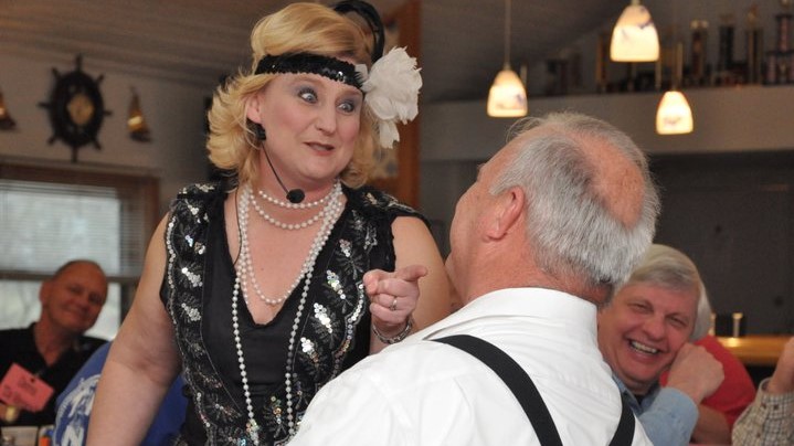 1920's flapper interrogates mobster at murder mystery Christmas party