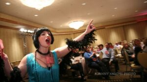 1920's flapper making accusations at company Christmas party murder mystery