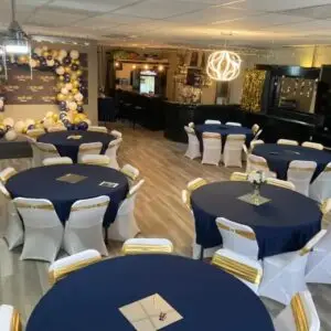 Large private event space with round banquet tables arranged for a group celebration or corporate gathering